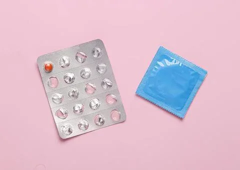 Condoms and empty blister pack on pink background 写真素材