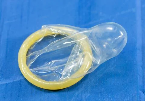 Condoms on blue background Stock Photos