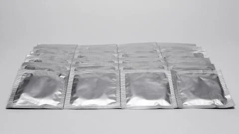 Condoms pack on a gray background Stock Photos