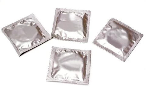 Condoms in seal package isolate on white background. Stock Photos