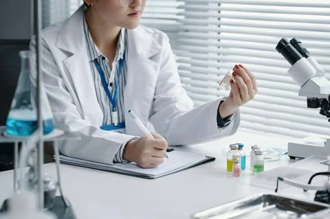 Conducting Experiment in Scientific Laboratory with Microscope Stock Photos