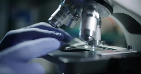 Conducting handson research with a microscope in lab for education Stock Footage 299715286
