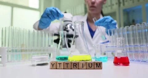 Conducting a lab experiment with Yttrium and colorful solutions to analyze Stock Footage 308861490