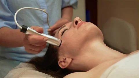 Conducting RF Wrinkle Reduction Therapy on facial skin for smoothness. Providing Stock Footage 329068382