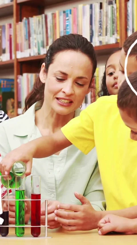 Conducting science experiment, teacher and children with math and science Stock Footage 344693910