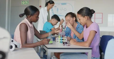 Conducting science experiment with test tubes and beakers, students in school Stock Photos