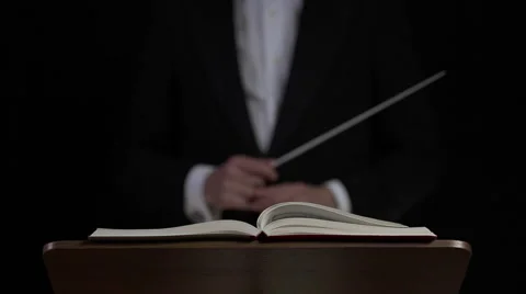 Conductor concentrates before starting to direct.  Stock Footage 61018422