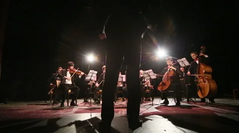 Conductor conducting an orchestra Stock Footage