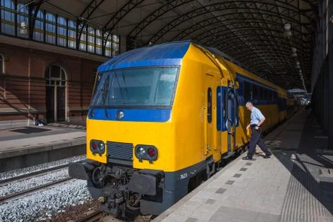 Conductor getting in a train ready to start in the hague, the netherlands Stock Photos