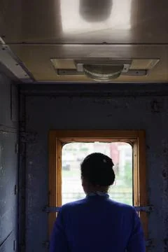 Conductor looking out the window on a train in Mongolia. Foto stock