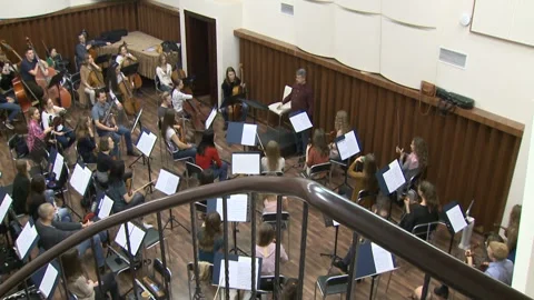 Conductor performed in front of an orchestra of folk instruments Stock-Footage 98574017