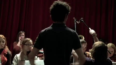 Conductor playing in front of orchestra Stock Footage 10870964