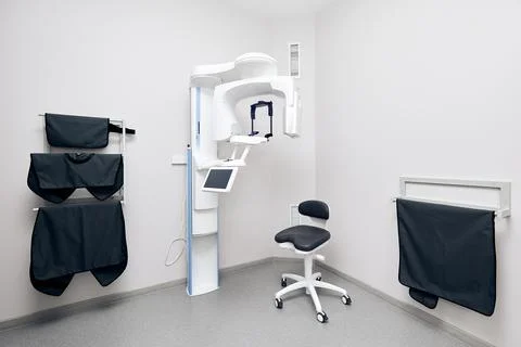 Cone beam computer tomography and protective cape in clinic Stock Photos