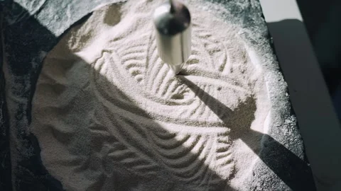 The cone draws patterns on the sand. Filming of scientific research Stock Footage 256054245