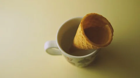 Cone in a mug on yellow background. panning to right Stock Footage 103276473