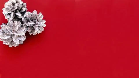 Cones in sequins on a red background with copy space Stock Photos