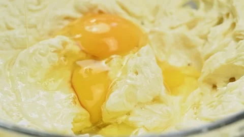 The confectioner adds an egg to the mixture. Process of making dough. 스톡 동영상 169797871