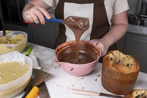 Confectioner checking the correct texture of the melted chocolate. Stock Photos