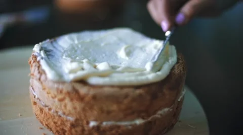Confectioner covers cake by cream Stock Footage 67517526