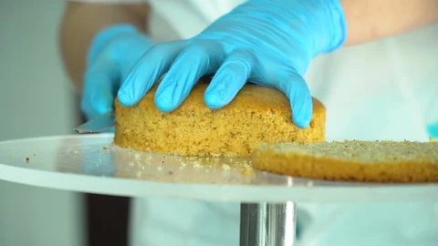 Confectioner cuts cake into layers Stock Footage 85666095