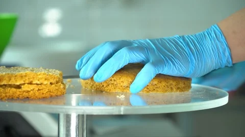 Confectioner cuts cake into layers Stock Footage 85666362