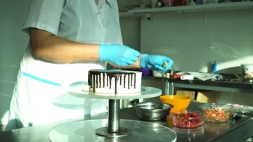 Confectioner decorates cake with biscuits Stock Footage 85667719