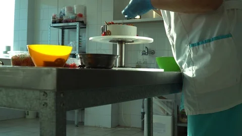 Confectioner decorates cake Stock Footage 85668190