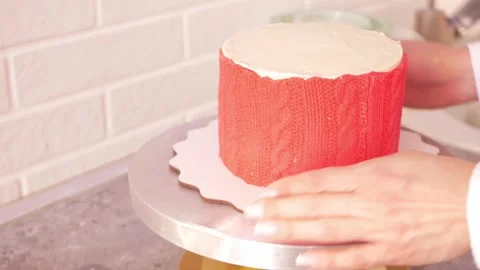 Confectioner Decorates cake with red mastic in form of knitted pattern. Home Stock Footage 165892408