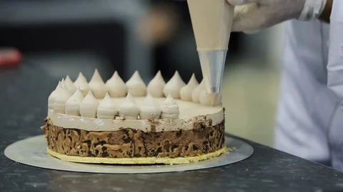 Confectioner decorates cake. Workshop how to make a cake. 스톡 동영상 106550990