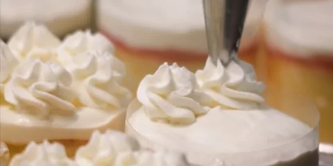 Confectioner Decorating Cake With White Whipped Cream Frosting Using Piping Bag Stock Footage 343589078