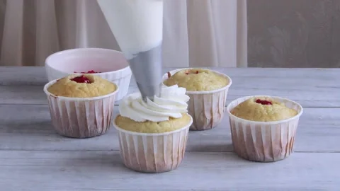 Confectioner decorating cupcakes with cream. Process of professional cooking. Cl Stock Footage 150463747