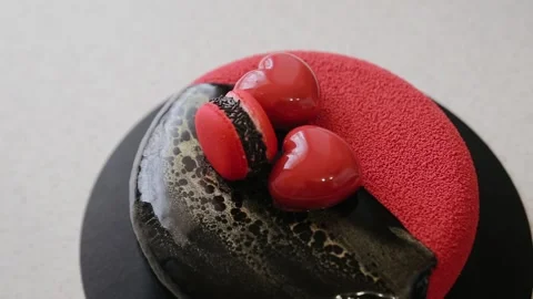 Confectioner decorating velour coating cake with heart-shaped elements macaron Stock Footage 134681315