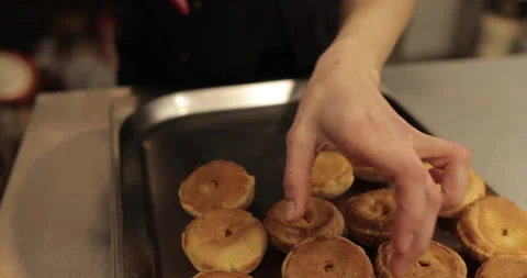 The confectioner fills the eclair with cream using a pastry syringe. Stock Footage 254816331