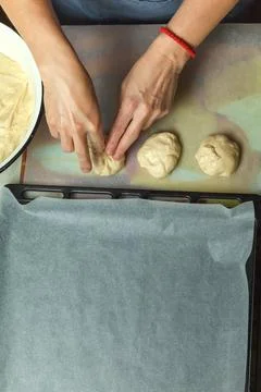 Confectioner forms buns with cherries from baking dough 스톡 사진