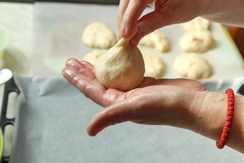 Confectioner forms buns with cherries from baking dough 스톡 사진