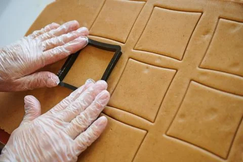 The confectioner forms gingerbread cookies using an original rectangular cutting Stock Photos