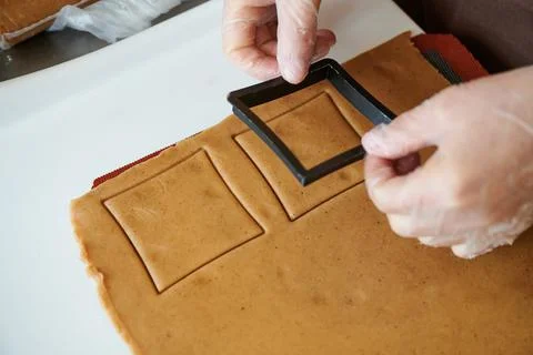 The confectioner forms gingerbread cookies using an original rectangular cutting Stock Photos