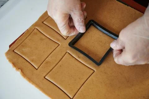 The confectioner forms gingerbread cookies using an original rectangular cutting Stock Photos