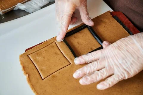 The confectioner forms gingerbread cookies using an original rectangular cutting Stock Photos