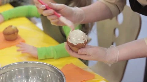 Confectioner glazing  cupcake using pastry brush 스톡 동영상 58185966