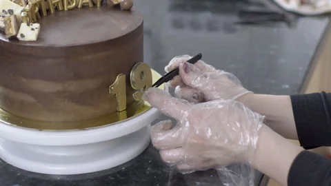 Confectioner in gloves makes a cake to 19th anniversary of birthday. Stock Footage 86497646