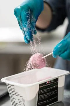 Confectioner in gloves makes chocolates in forms Stock Photos