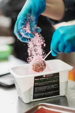 Confectioner in gloves makes chocolates in forms Stock Photos