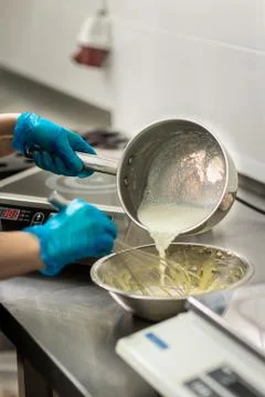 Confectioner in gloves makes chocolates in forms Stock Photos