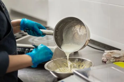 Confectioner in gloves makes chocolates in forms Stock Photos
