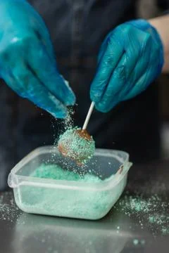 Confectioner in gloves makes chocolates in forms Stock Photos