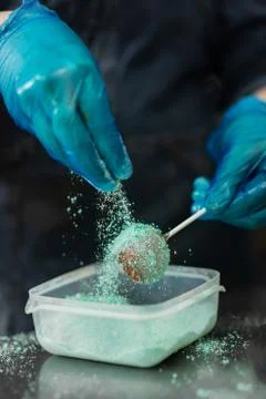 Confectioner in gloves makes chocolates in forms Stock Photos