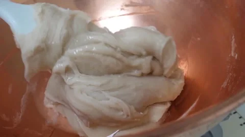 Confectioner Kneading White Taffy Paste in Copper Bowl Stock Footage 345293559