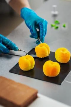 Confectioner makes a cake in the shape of fruits and berries Stock Photos