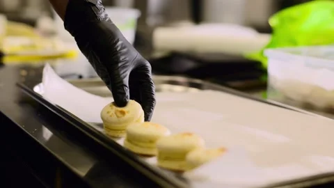 A confectioner makes macaroons in a pastry shop. Stock Footage 233299522